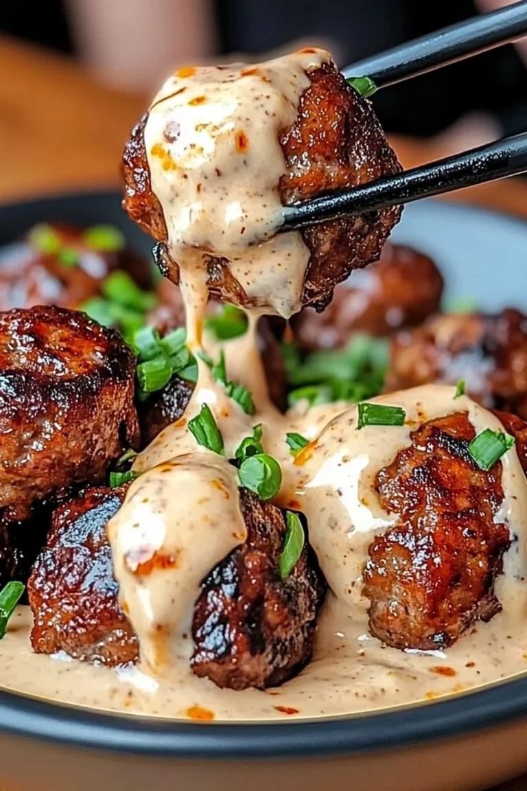 Korean BBQ meatballs served with spicy mayo dip on a wooden plate.