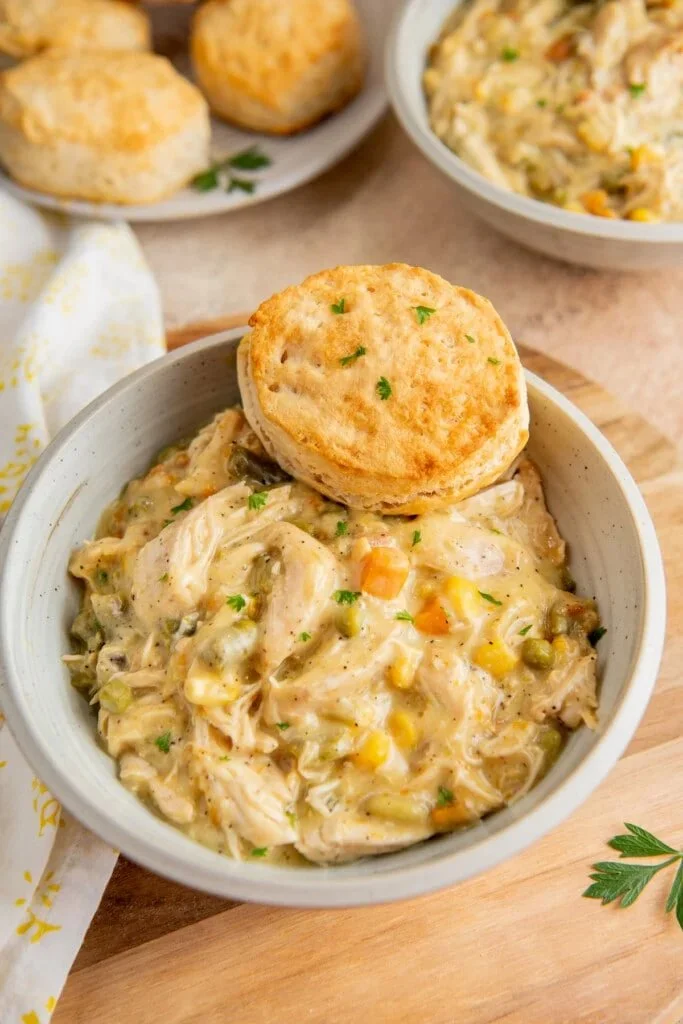 Delicious Crock Pot Chicken Pot Pie served in a bowl with fresh herbs.