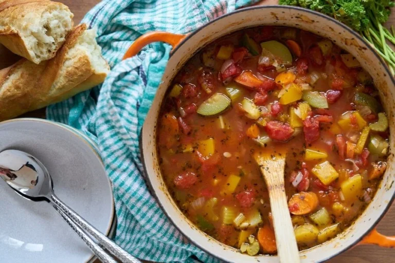 Bowl of fall harvest vegetable soup with colorful seasonal vegetables.