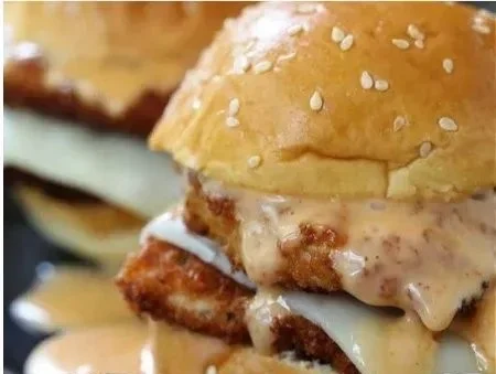 Delicious Bang Bang Chicken Sliders served on a platter with fresh toppings