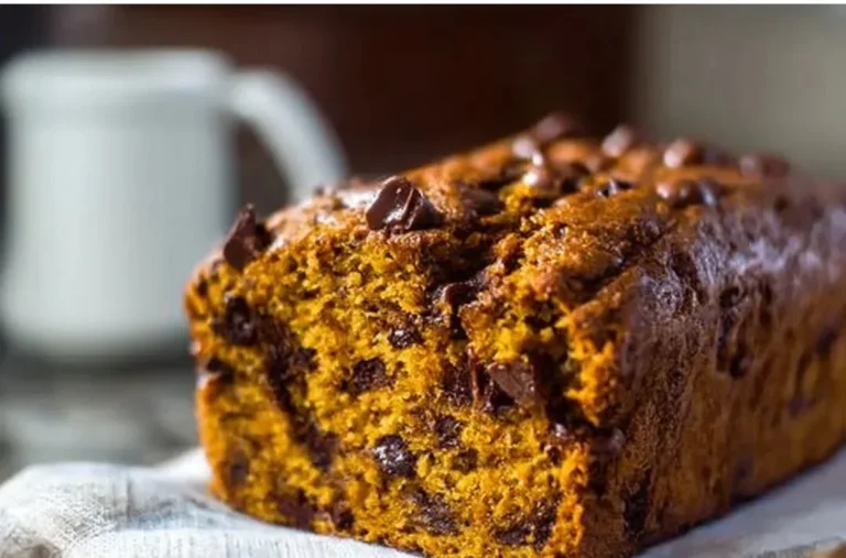 Delicious banana chocolate chip pumpkin bread loaf on a wooden table