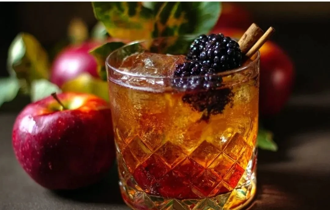 Poisoned Apple Cider Cocktail with apple slices and garnish