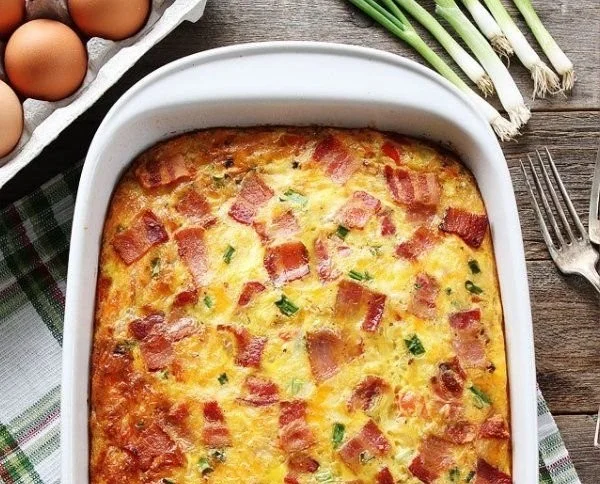 Delicious bacon, potato, and egg casserole served warm on a plate.