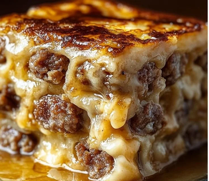 Delicious pancake sausage casserole served on a plate topped with maple syrup