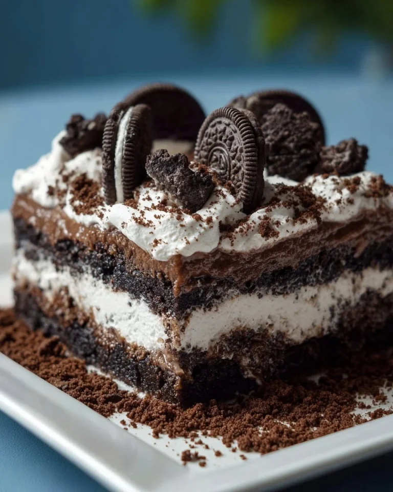 Delicious Oreo Dirt Cake topped with crushed Oreos and chocolate pudding.