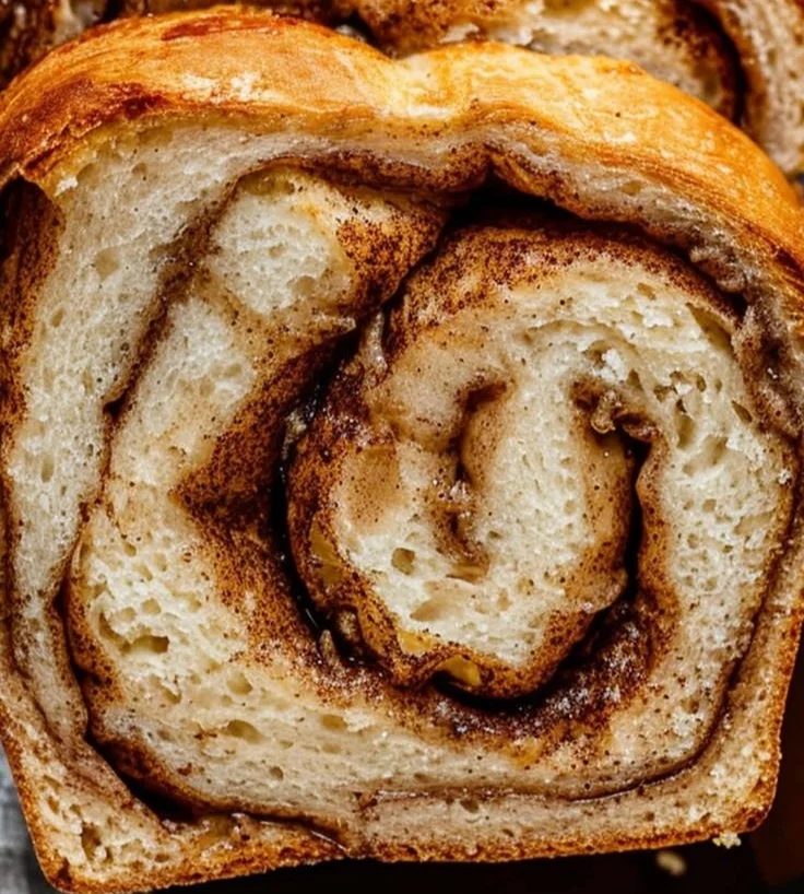 Homemade cinnamon swirl bread with a golden crust and rich, spiced filling.