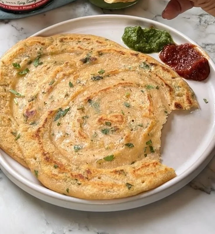 Delicious red lentil pancake served with toppings