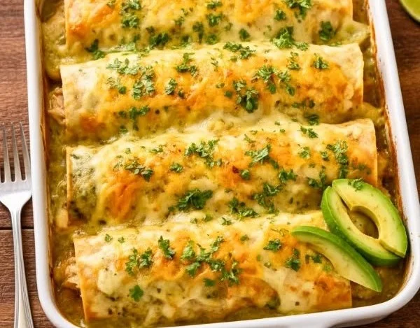 Joanna Gaines' flavorful chicken enchiladas served on a plate with garnish