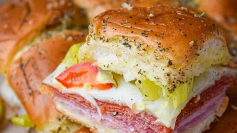 Hot Italian sub sliders with savory meats and melted cheese in soft buns