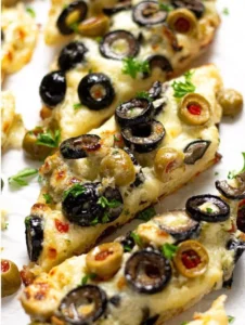 Freshly baked Olive Cheese Bread with olives and melted cheese on top.